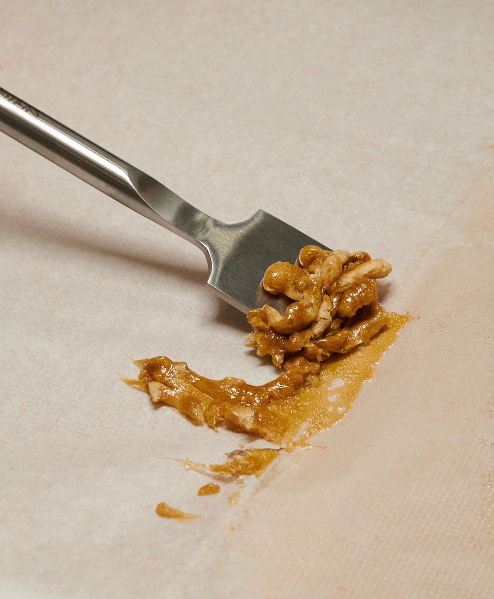 Hand scrapping pure thc pressed rosin.