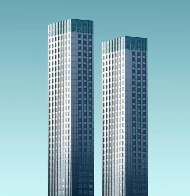 two buildings with blue background
