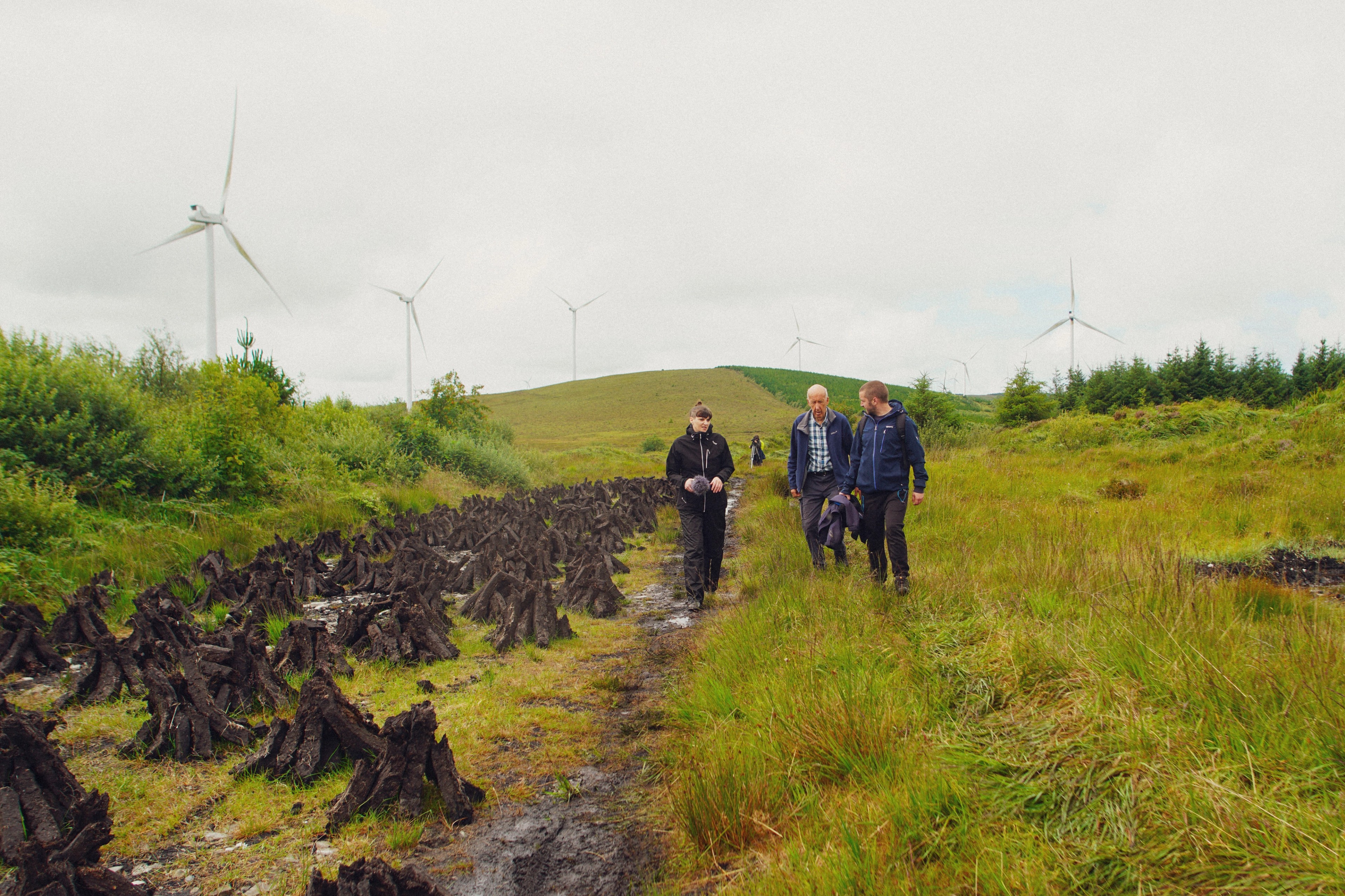 Artists and participant walking in Lyreacrompane Bog