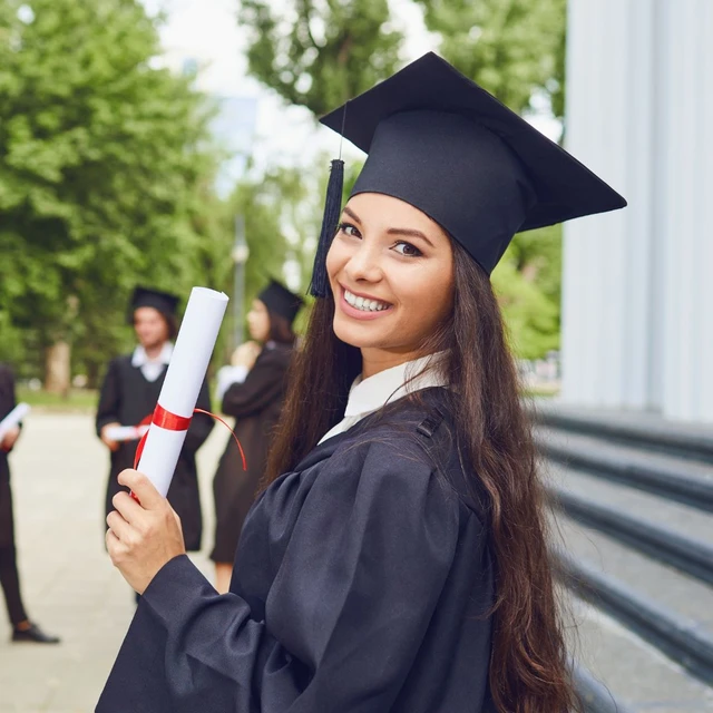 A student showing her degree certificate after graduation ceremony
