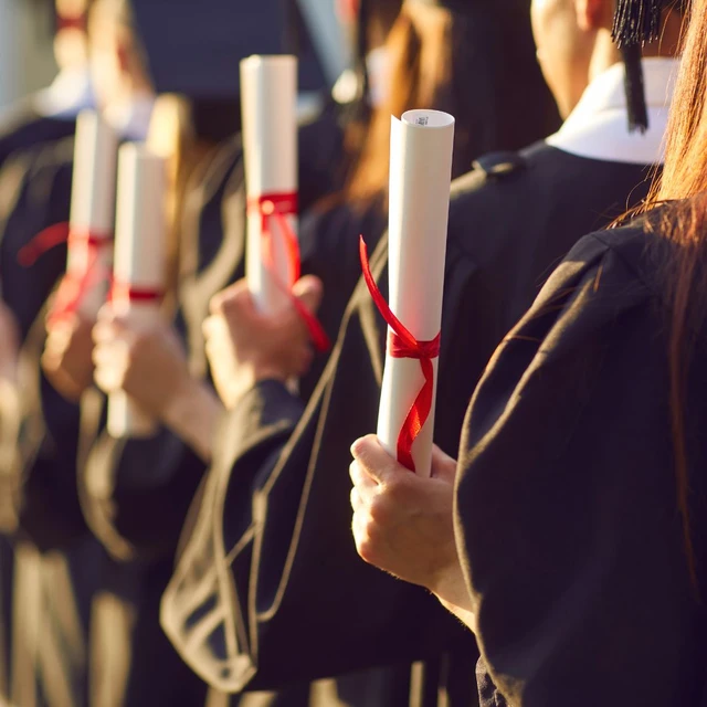 Students holding thier degree certificates