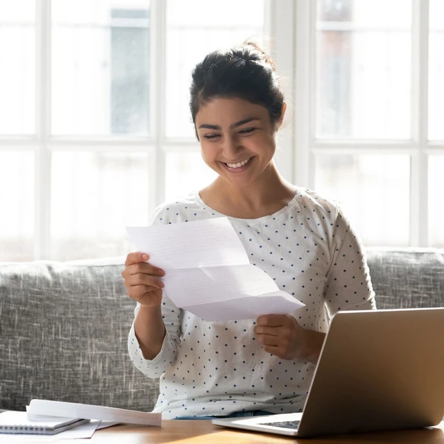 A happy student reviewing her approved student visa