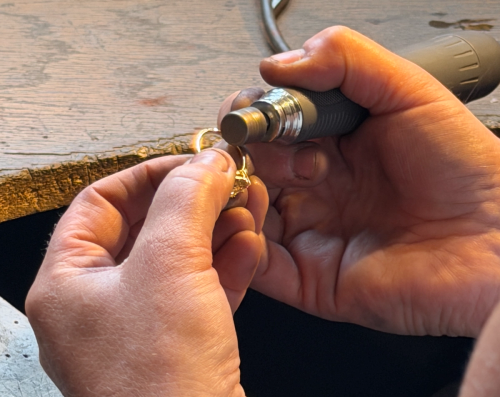 Nangi goldsmith in Oslo polishing a gold ring during the Nangi Care annual jewelry service