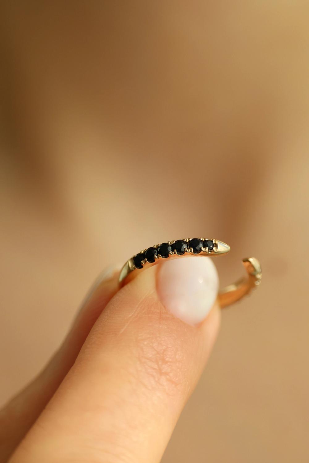Stacking ring with opening with small black round sapphires set in half-eternity