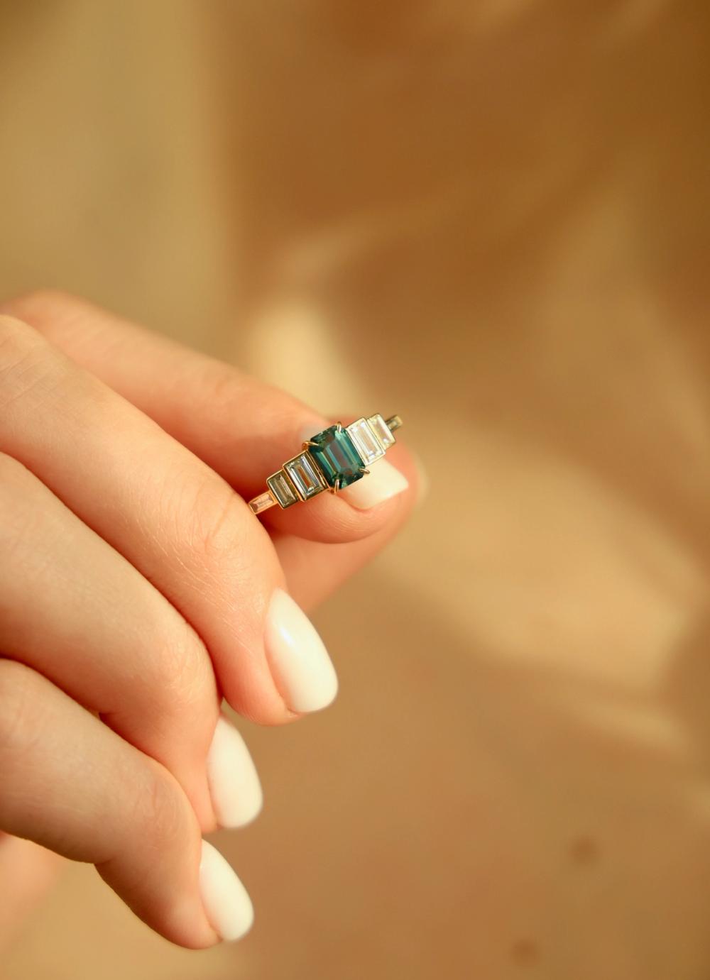 Three stone ring teal sapphire set in yellow gold with baguette cut lab-grown diamonds
