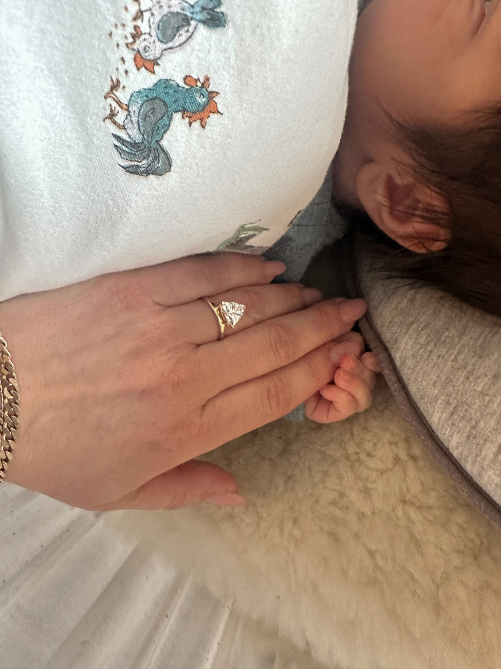 2.00-carat trillion-cut diamond, one point for each of her three children.