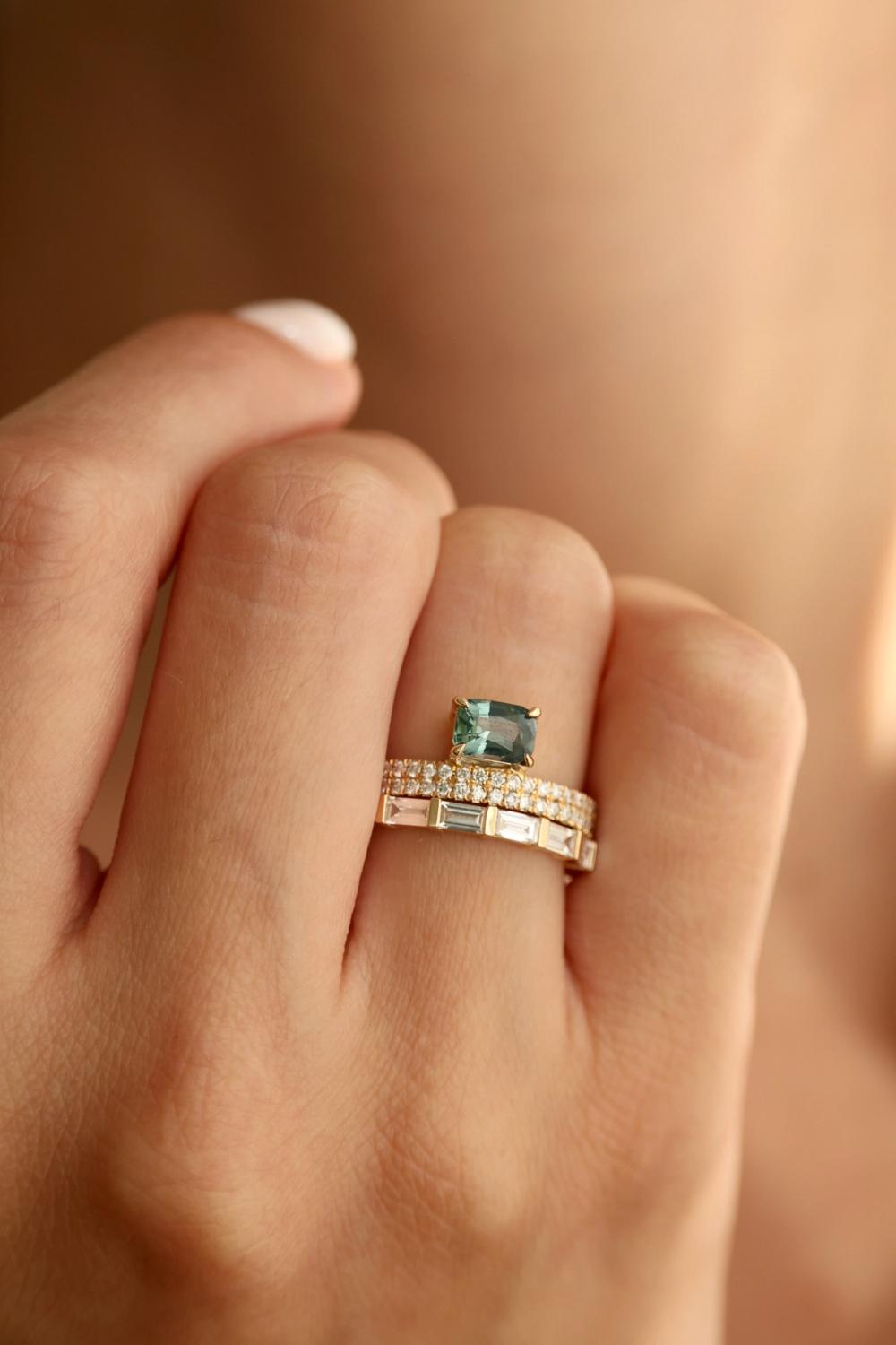 Green sapphire set in solid yellow gold with diamonds