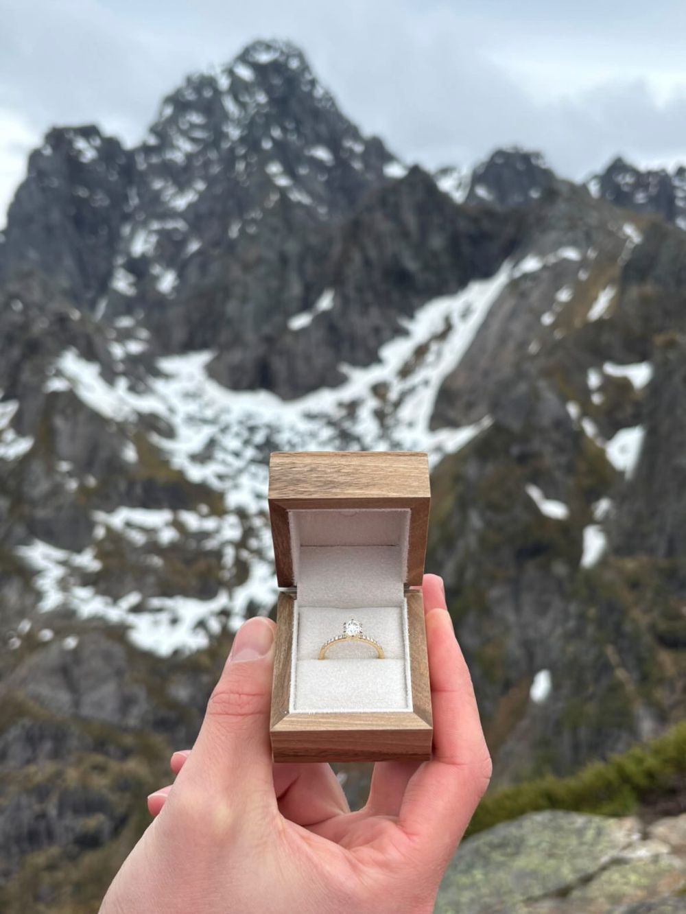 Ring proposal with diamond ring in box at the top of Lofoten, Norway