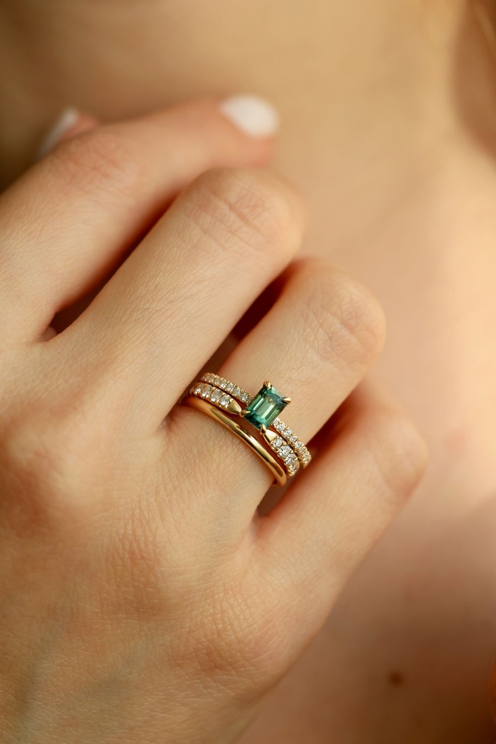 Green emerald cut sapphire with pavé diamonds set in 14K yellow gold