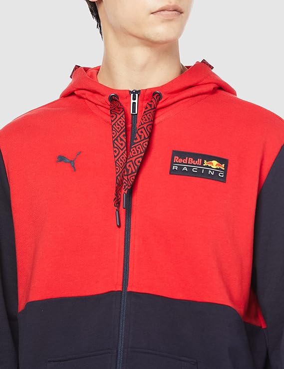 A person wears a red and navy Red Bull Racing zip-up hoodie with a PUMA logo and branded drawstrings.