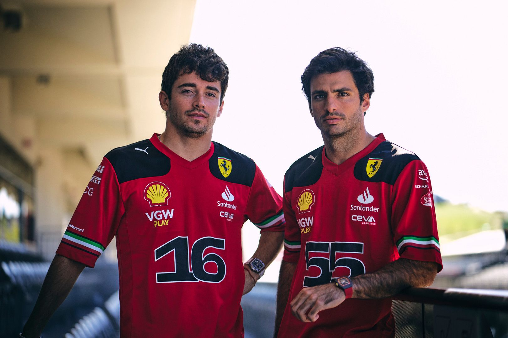 Ferrari F1 drivers Charles Leclerc (16) and Carlos Sainz (55) in red team shirts.