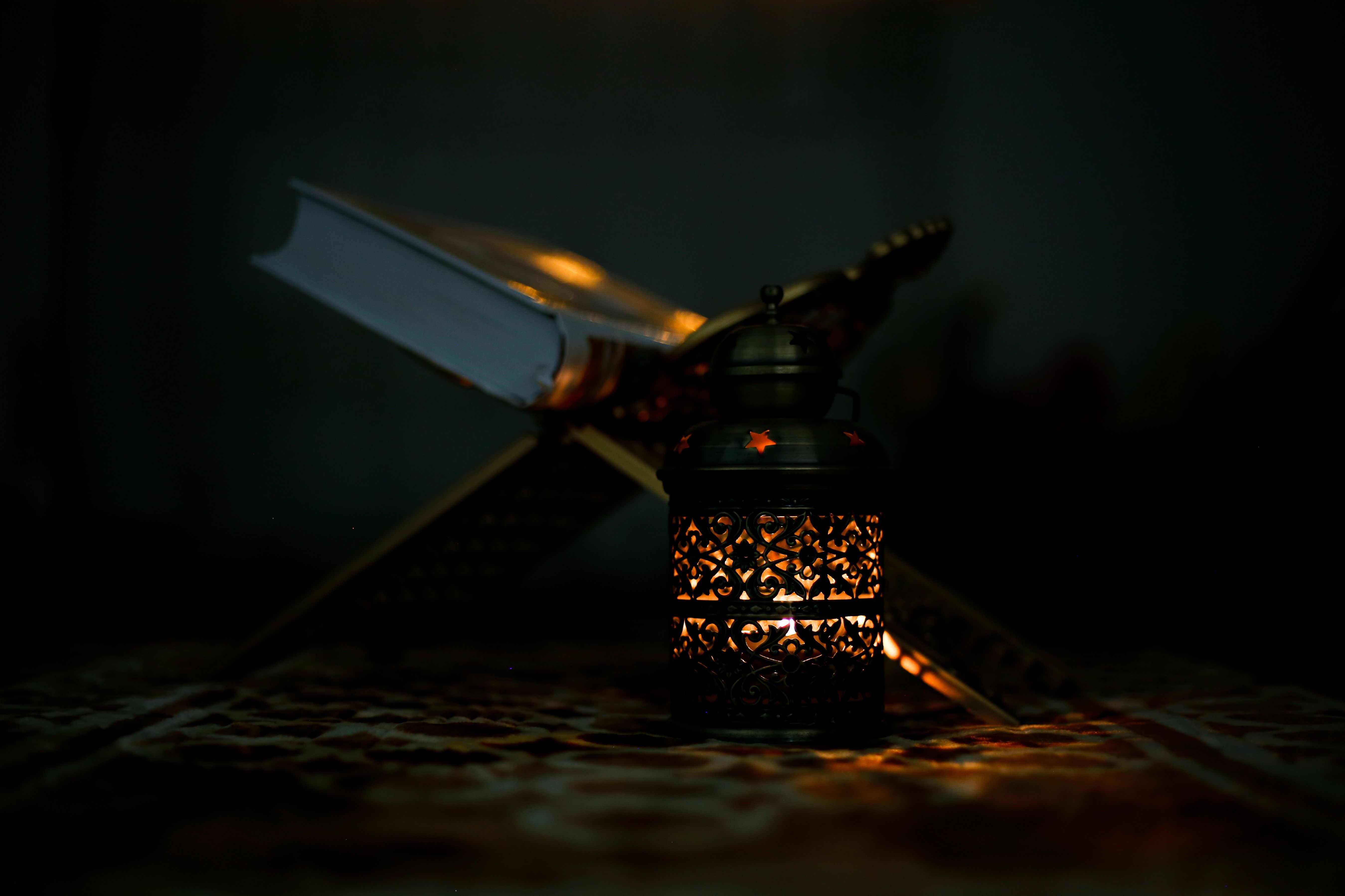 Lantern and a book in darkness