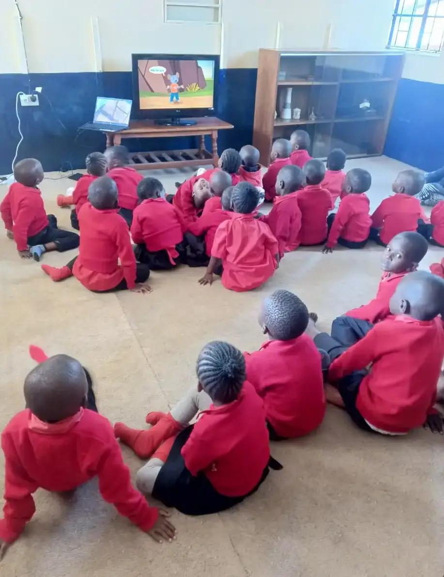 Young learners watching a classroom learning activity.