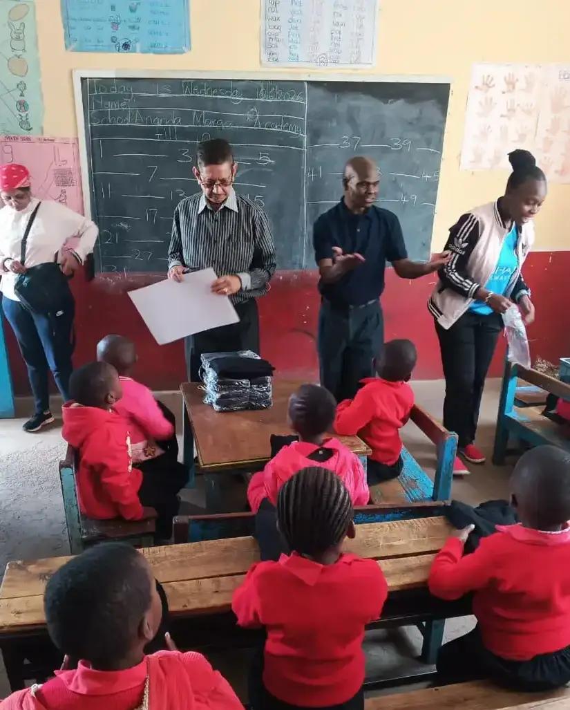 Visitors spending time with children in the classroom.