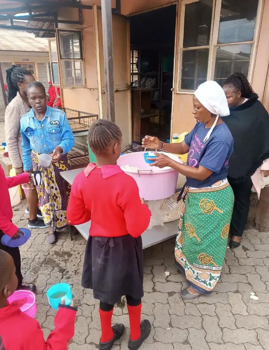 Serving a meal to pupils at school.