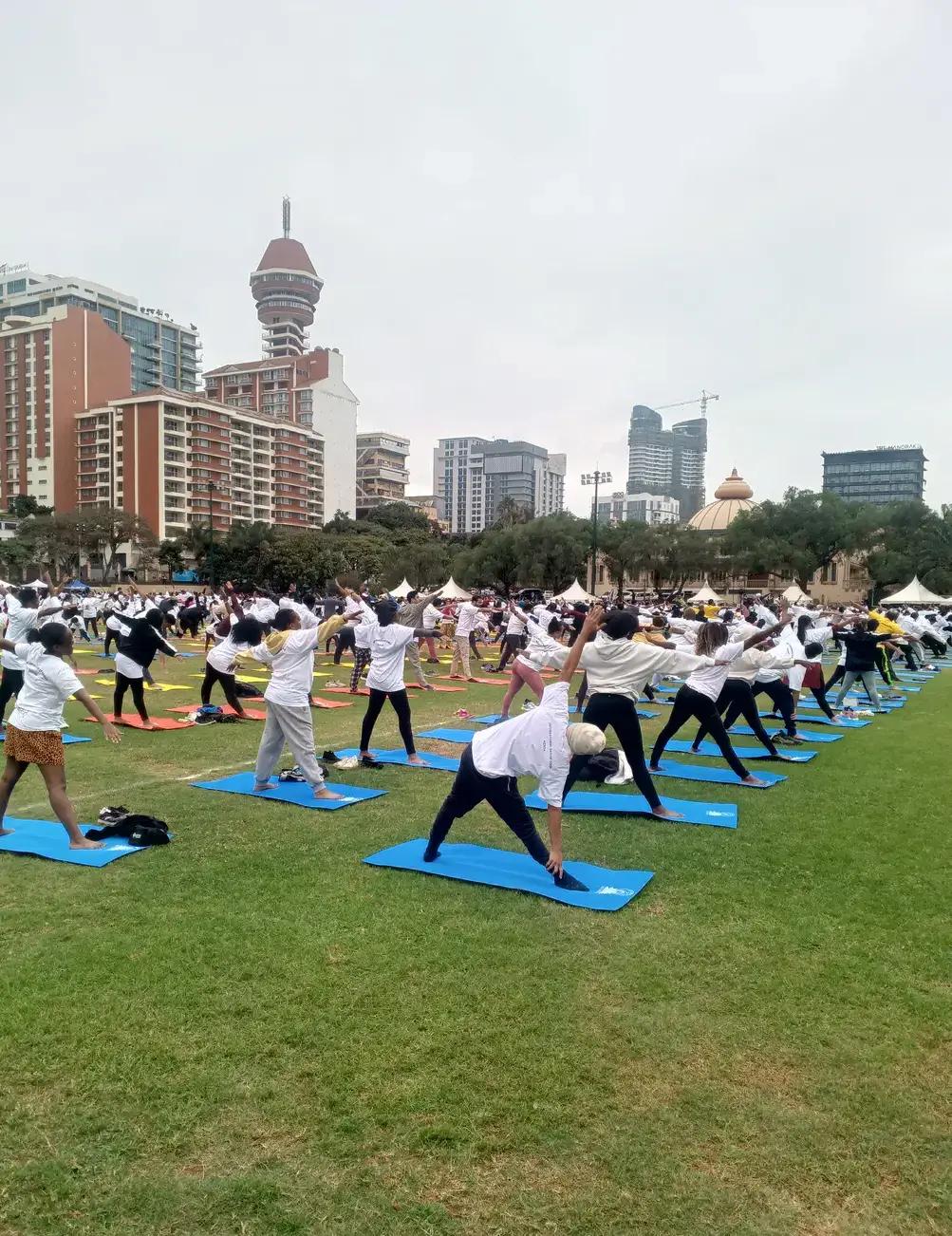 Participants practising standing yoga poses.