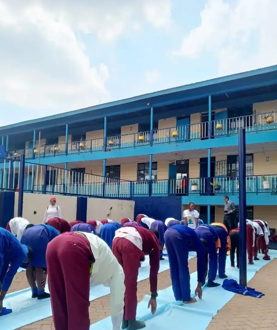 A group stretching session in the school courtyard.