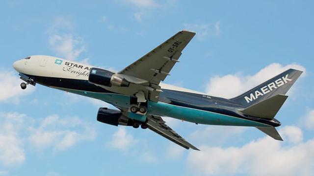 Maersk Star Air Freight cargo jet climbing against a blue sky with scattered clouds