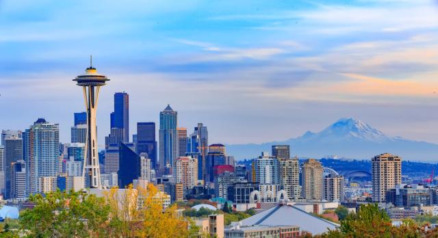 Seattle skyline at dusk with the Space Needle and snow-capped Mount Rainier in the distance