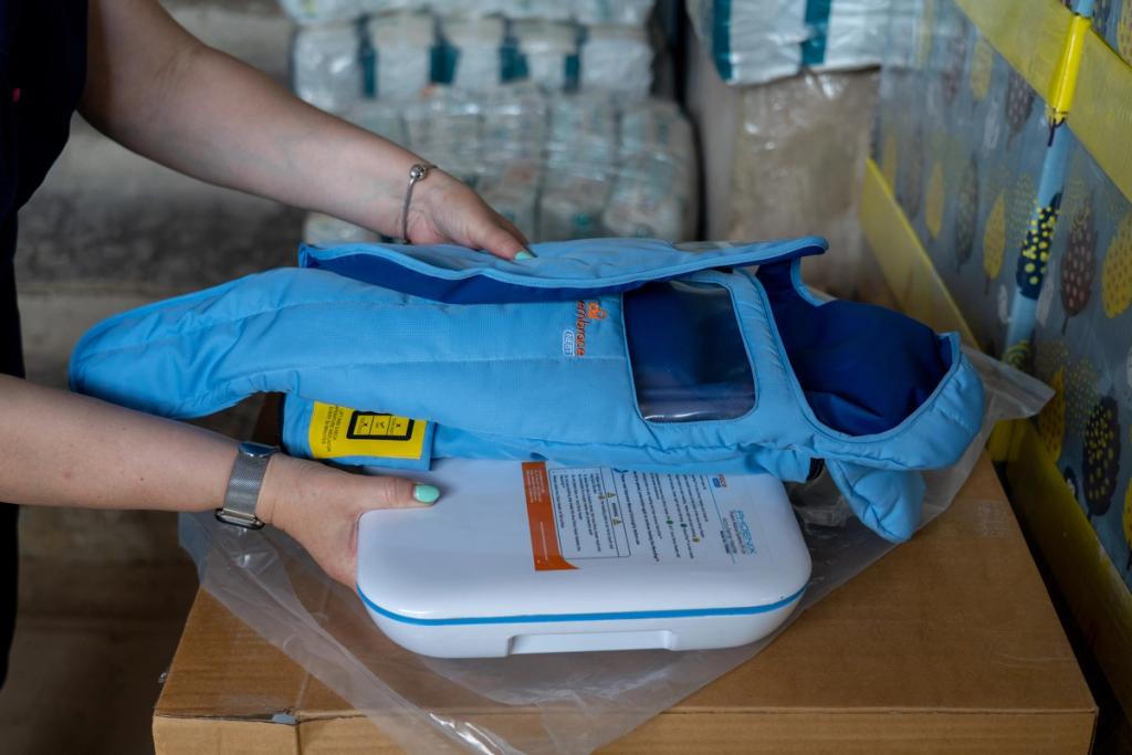Hands place an inflatable child life jacket and its white case on a cardboard box in a warehouse.
