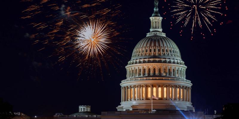 Fireworks bursting over the illuminated U.S. Capitol dome at night