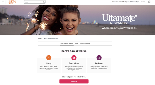 Ulta Ultamate Rewards web page with two laughing women holding sparklers and a three-step Shop, Earn More, Redeem panel.