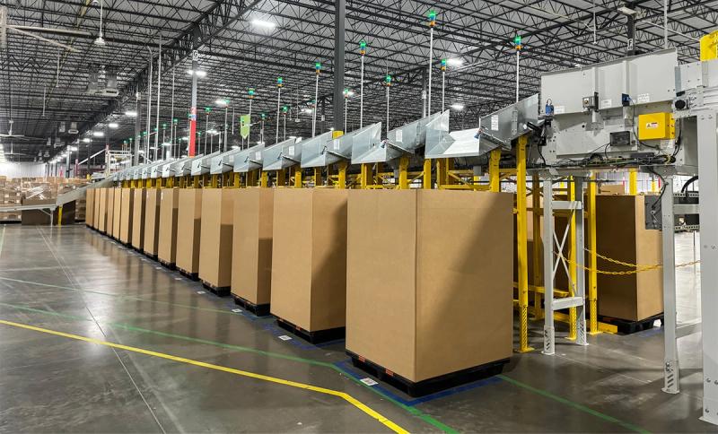 Atlanta fulfillment center with a row of large gaylord cartons staged along a conveyor line