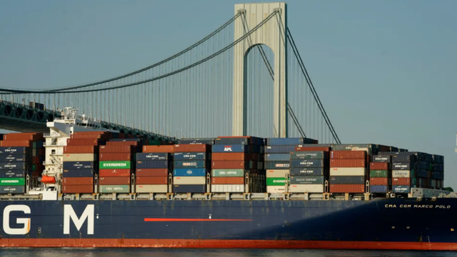 CMA CGM container ship stacked with shipping containers passing under the Verrazzano-Narrows Bridge