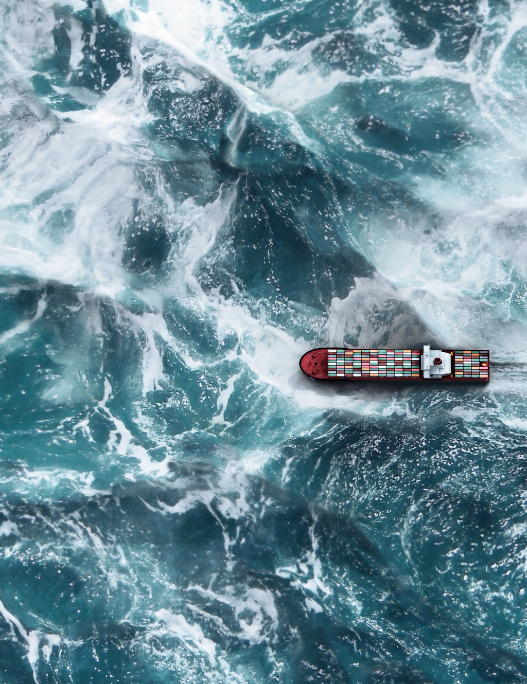 Container ship navigating through rough ocean waves.
