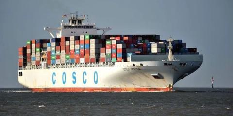COSCO container ship stacked with containers sailing on open water