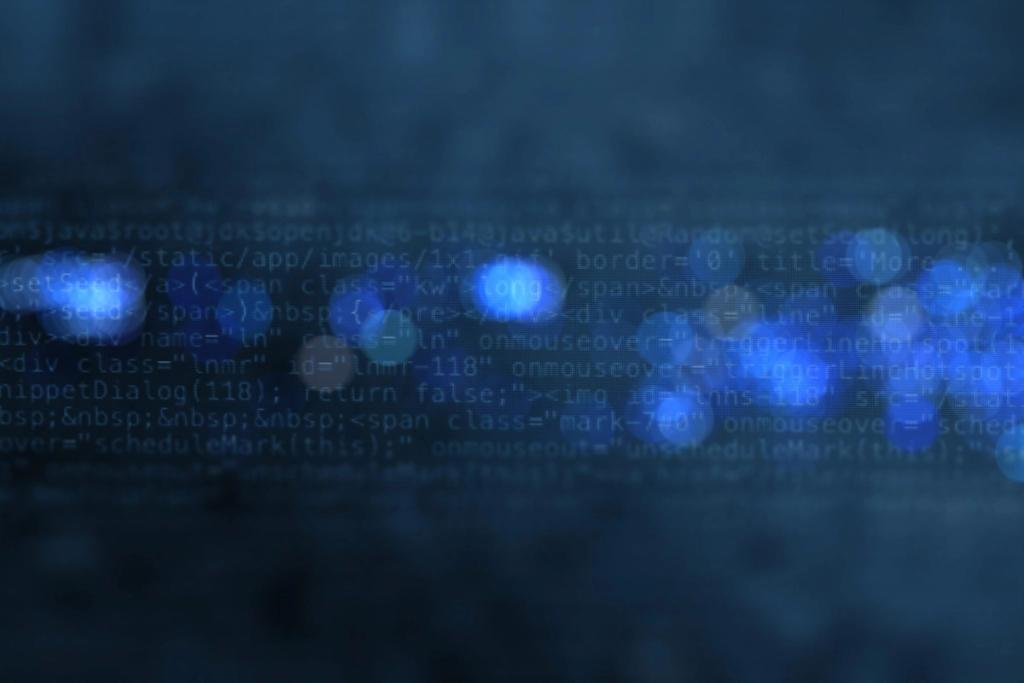 Blurred blue screen of HTML and JavaScript source code behind glowing bokeh light circles