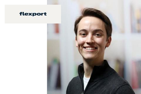 Smiling young person in a dark zip-up sweater beside a Flexport logo