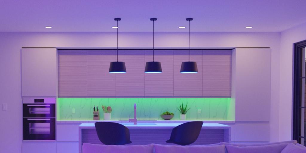 Modern kitchen lit with purple and green LED smart lighting, pendant lamps over a central island
