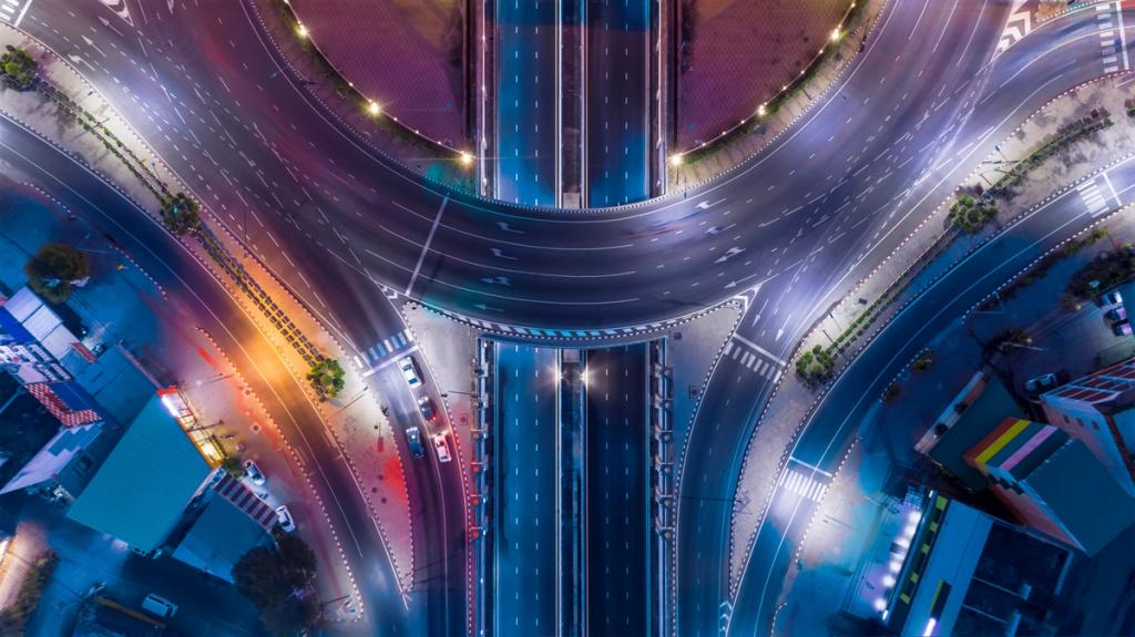 Aerial night view of a multi-lane highway interchange with overpasses and light trails