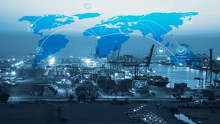 Aerial night view of a container port with cranes and stacked containers, overlaid with a glowing blue world map and connecting network lines