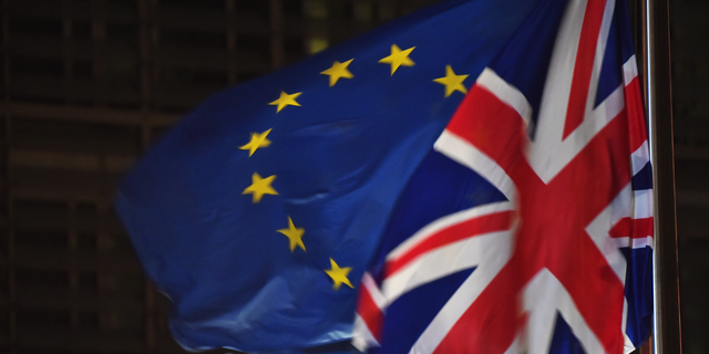 European Union flag and United Kingdom Union Jack flags flying side by side, representing Brexit