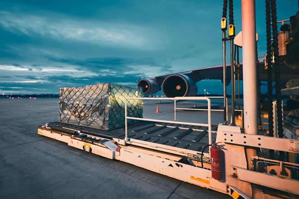 Air cargo pallet on a loader beside a wide-body freighter aircraft on the tarmac at dusk
