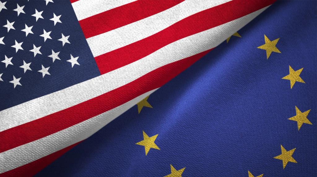 Close-up of the United States and European Union flags laid diagonally side by side, the stars and stripes meeting the EU circle of gold stars on blue.