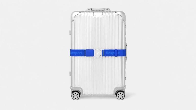 A luggage suitcase with straps securing the lid closed.