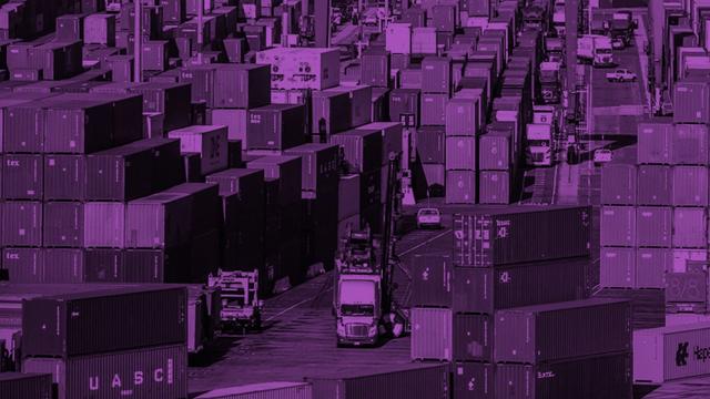 Truck driving between rows of stacked shipping containers at a port terminal, purple duotone overlay