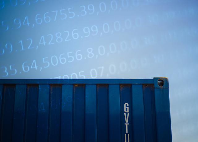 Blue shipping container marked GVTU with translucent data numbers overlaid against the sky