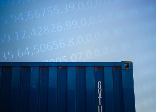 Blue shipping container marked GVTU with translucent data numbers overlaid against the sky