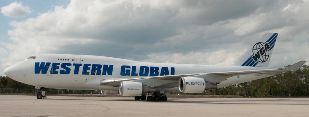 Western Global Airlines Boeing 747 freighter with Flexport branding on its engines parked on a tarmac