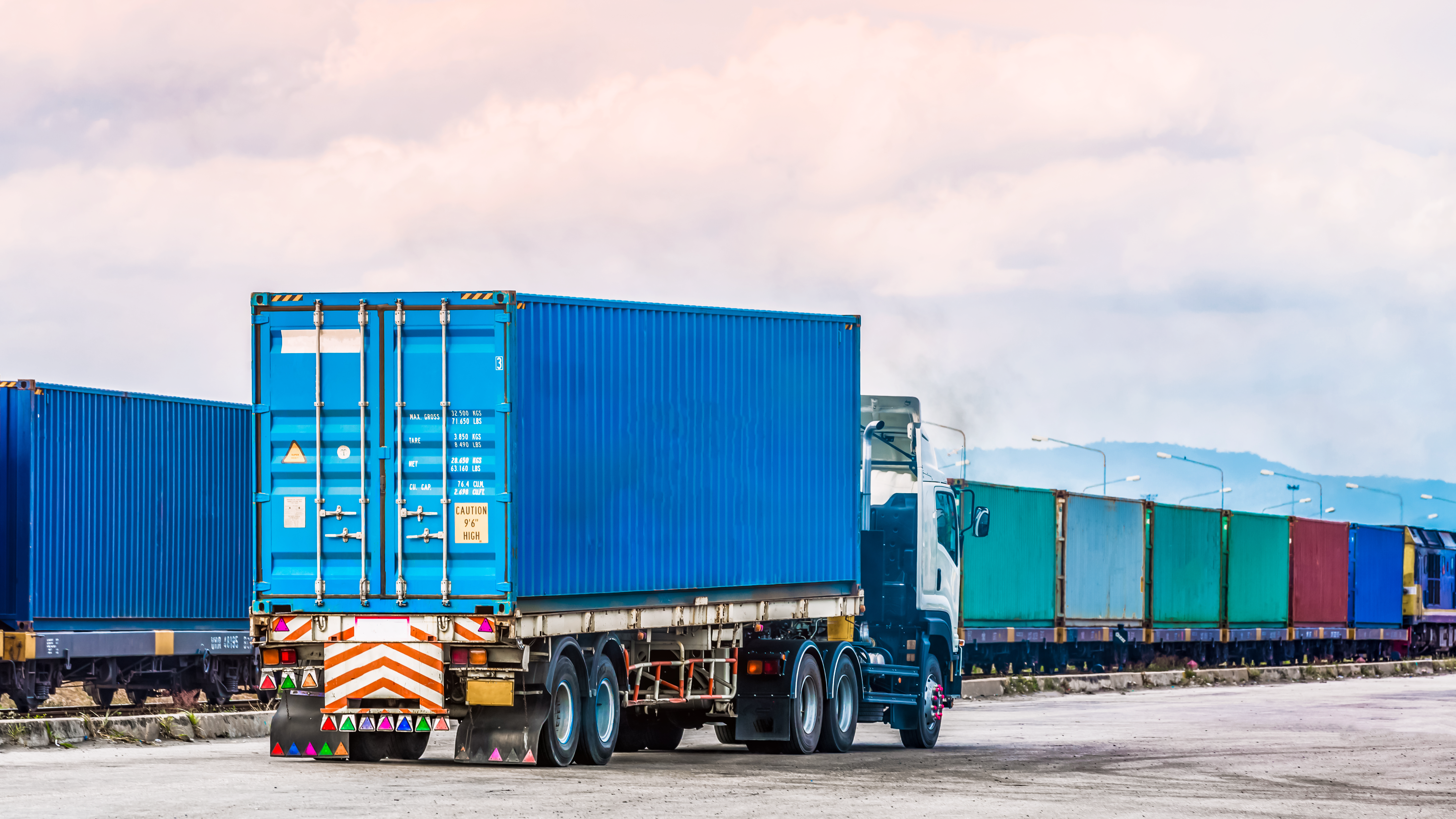 Large truck hauling a container at a port