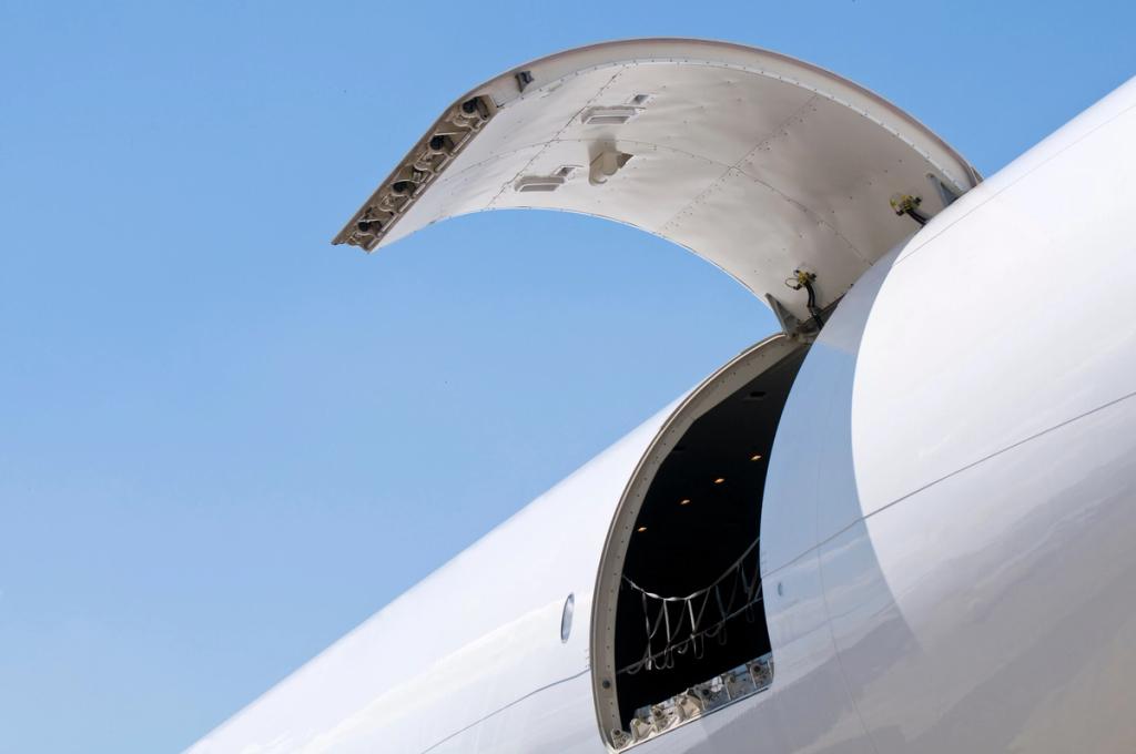 Cargo door of a large transport aircraft open against a clear sky.