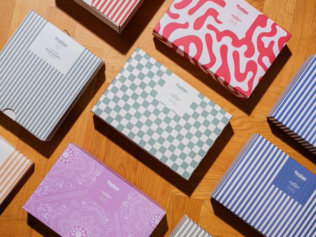 Patterned Pockies gift boxes in stripes, checks and swirls arranged on a wood floor