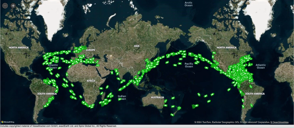 World map satellite view with green dots marking dense clusters of ships along global shipping routes