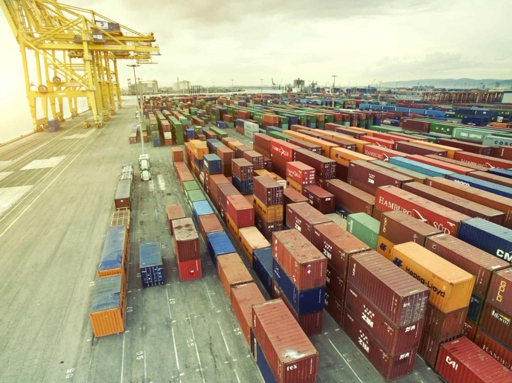 Elevated view of stacked shipping containers and gantry cranes filling a port yard