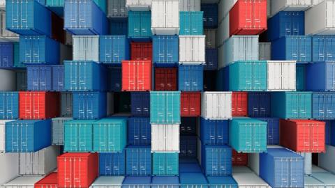 Wall of stacked red, blue and white shipping containers