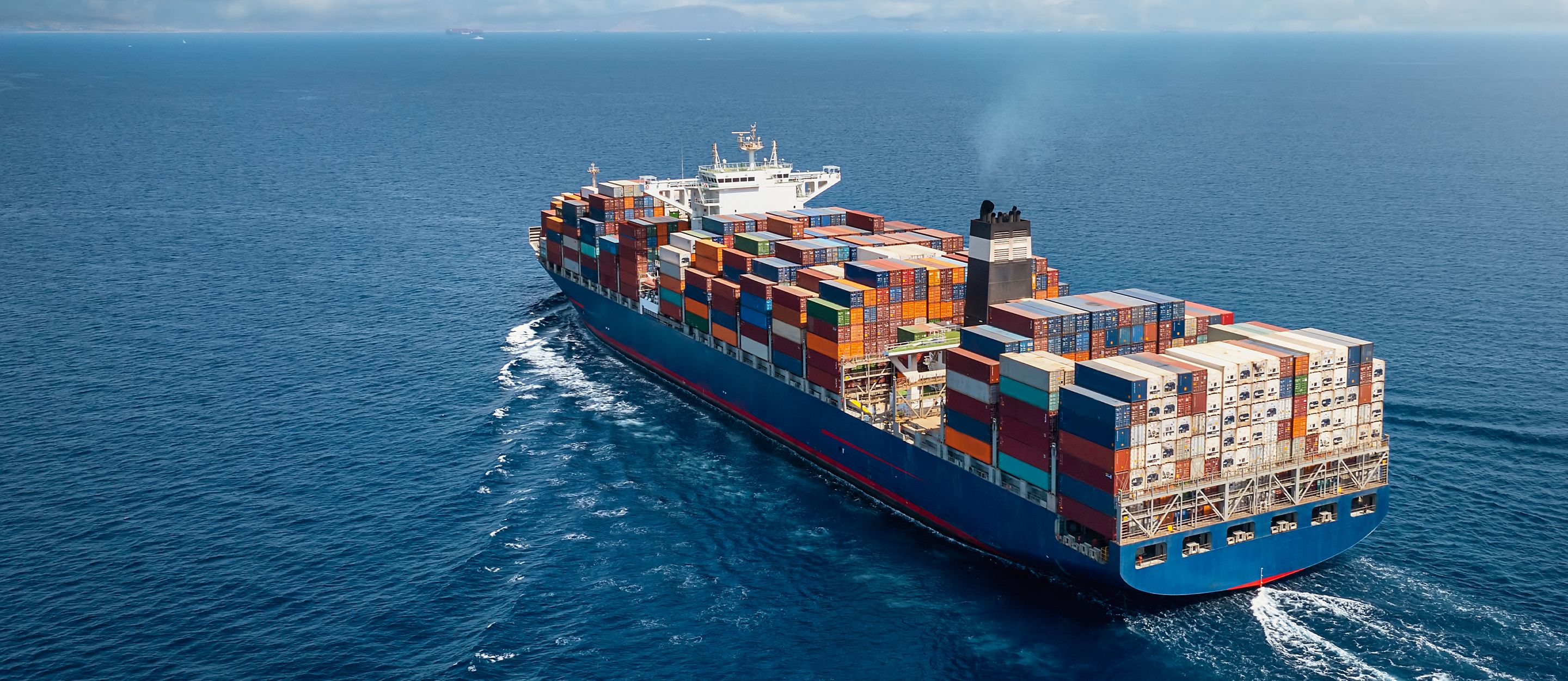 Large container ship sailing on open ocean